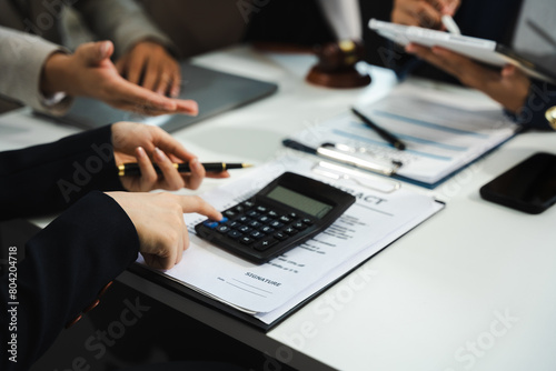 Business people and lawyers discussing contract papers sitting in the table at office in the morning. concepts of law, advice, legal services.