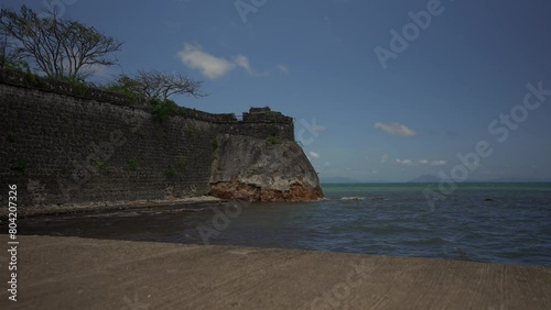 Rising reveal from behind foreground of Fort Santa Isabel, a coastal fort from Spanish colonial times built in Taytay, Philippines. photo