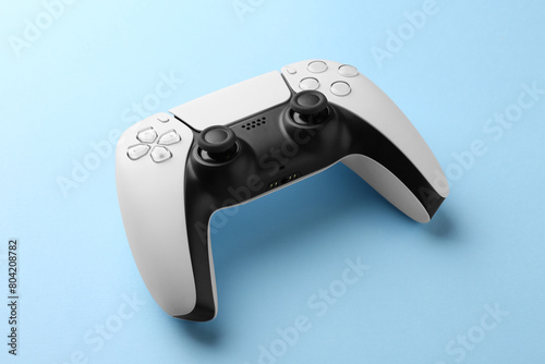 Wireless game controller on light blue background © New Africa