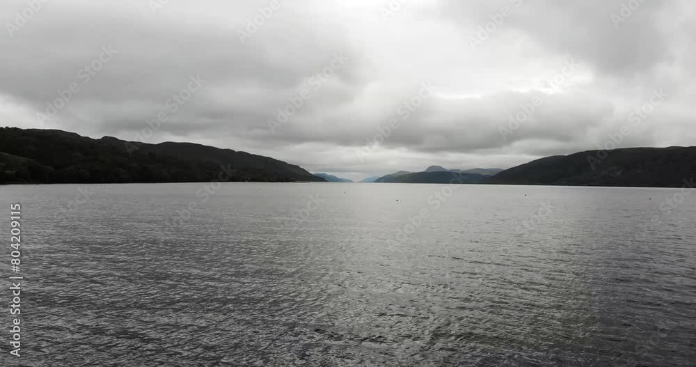 Aerial Flying Over Waters Of Loch Ness With Clouds Overhead. Push Forward, Establishing Shot Aerial Flying Over Waters Of Loch Ness With Clouds Overhead. Push Forward, Establishing Shot