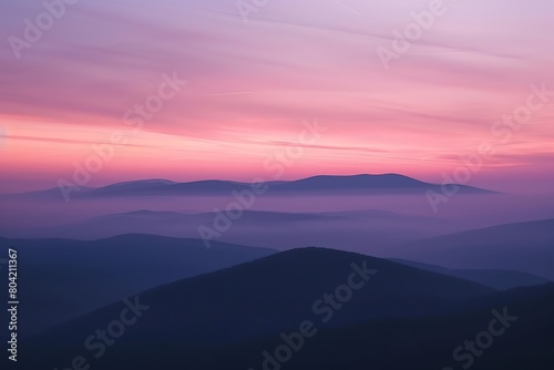The smooth contour of a hill under a pastel sunset