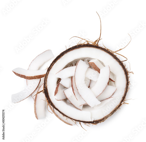 Coconut pieces in nut shell isolated on white, top view