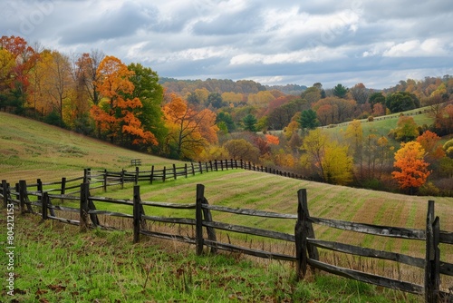 A wooden fence stands in front of a vibrant green hillside, adding a rustic touch to the serene countryside landscape
