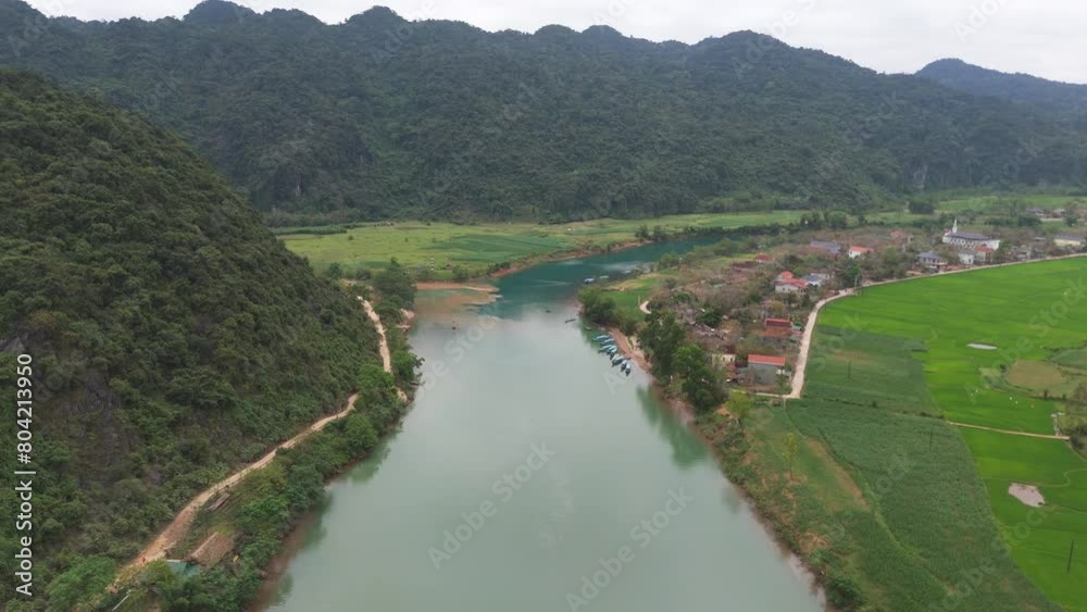 Aerial Drone Shot of River Passing Through Mountain Range with Grass Fields in Vietnam Aerial Drone Shot of River Passing Through Mountain Range with Grass Fields in Vietnam
