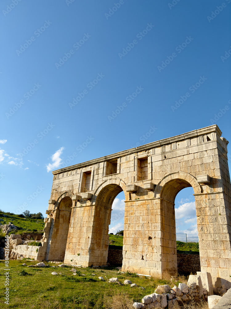 The ancient Roman gate in Patara, Antalya, Turkey, stands as a testament to the rich history of this region. The well-preserved stone arches showcase the architectural prowess of ancient civilizations The ancient Roman gate in Patara, Antalya, Turkey, stands as a testament to the rich history of this region. The well-preserved stone arches showcase the architectural prowess of ancient civilizations