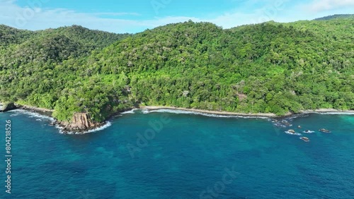 The lush batu kapal beach on weh island, indonesia, with clear blue waters and dense forest, aerial view photo