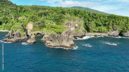 Batu kapal beach on weh island, showcasing lush greenery and rocky coastline under clear blue skies, aerial view photo