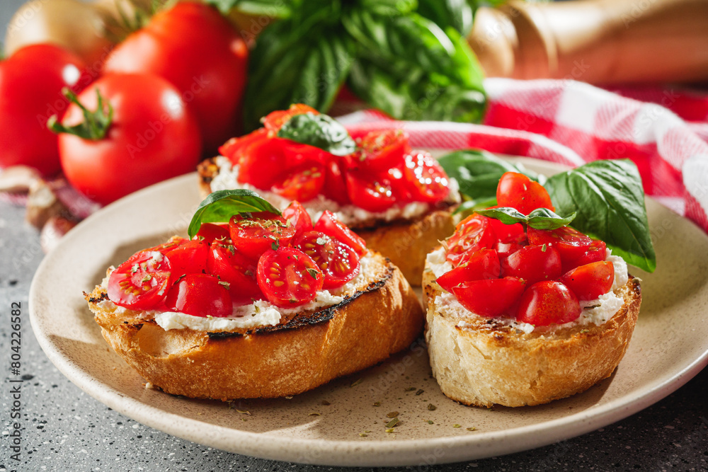 delicious Italian bruschetta with tomatoes on a light stone background