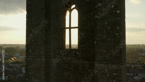 Golden hour aerial orbit around 12th-century Augustinian Abbey tower. Trim, Ireland photo