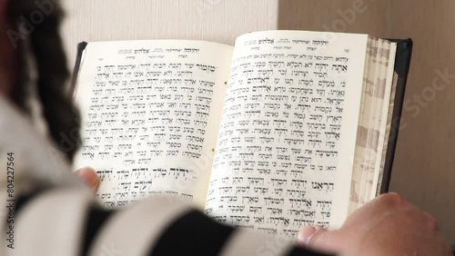 Hand of young boy reading the Jewish Torah at Bar Mitzvah Bar Mitzvah Torah