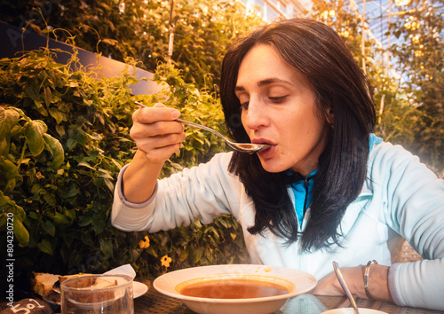 South Iceland-2nd march, 2023: caucasian tourist woman visitor eat portion of mussels in Fridheimar - visitors friendly tomato farm and restaurant in Iceland