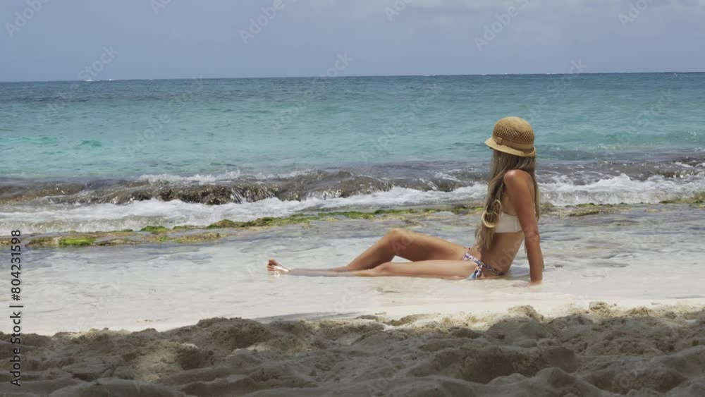 Beauty woman lying on the edge of the sea sunbathing Beauty woman lying on the edge of the sea sunbathing