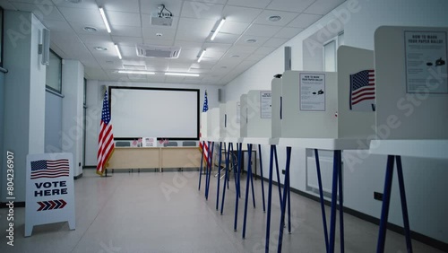 Voting booths with American flag logo in polling station office. The lights turn off. End of the National Election Day in the United States of America. Political races of US presidential candidates.