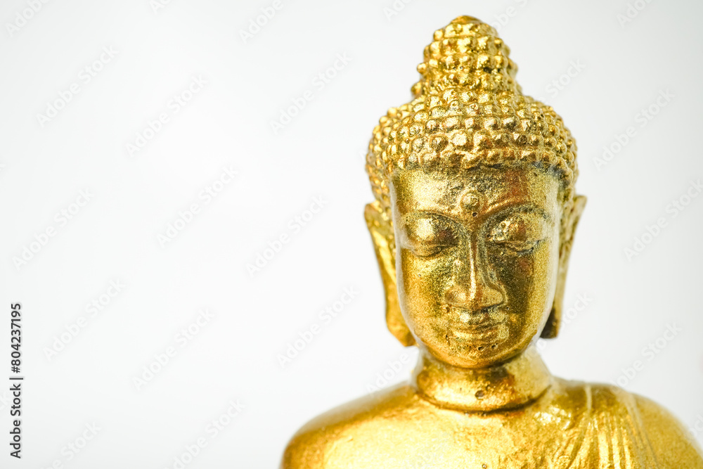 A golden statue of a Buddhist figure meditating facing the front isolated on white background. Bodhisattva Face. Concept for Vesak Day and Enlightenment Day A golden statue of a Buddhist figure meditating facing the front isolated on white background. Bodhisattva Face. Concept for Vesak Day and Enlightenment Day