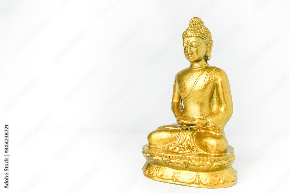 A golden statue of a Buddhist figure meditating facing the side isolated on white background. Bodhisattva Face. Concept for Vesak Day and Enlightenment Day A golden statue of a Buddhist figure meditating facing the side isolated on white background. Bodhisattva Face. Concept for Vesak Day and Enlightenment Day