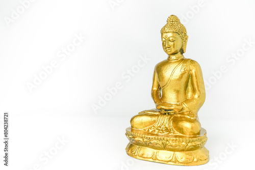 A golden statue of a Buddhist figure meditating facing the side isolated on white background. Bodhisattva Face. Concept for Vesak Day and Enlightenment Day