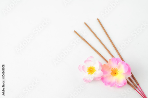 Isolated Empty white background decorated with colorful flowers and incense. Concept for Vesak Day and Enlightenment Day. Empty blank copy text space