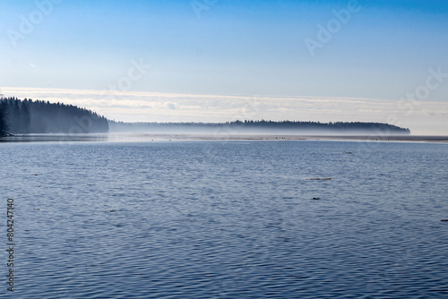 Morning spring fog near the horizon of the water surface of the large Onega Lake in Karelia. photo