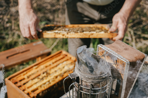 This vintage bee smoker, still active, sends out plumes of smoke, aiding beekeepers in maintaining hive harmony