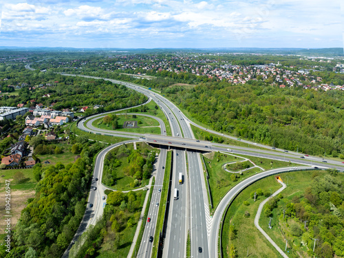 Krakow, Poland. Highway multilevel spaghetti junction on A4 international three lane motorway, the part of freeway around Cracow with local highway. Aerial view in spring