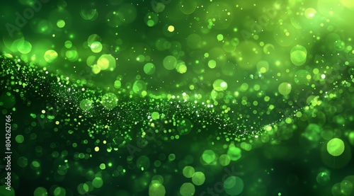 Abstract green particles background with bokeh lights and space for text. Glitter effect on dark background. Shiny glowing stars, stardust or fairy dust wallpaper design in the style of space.