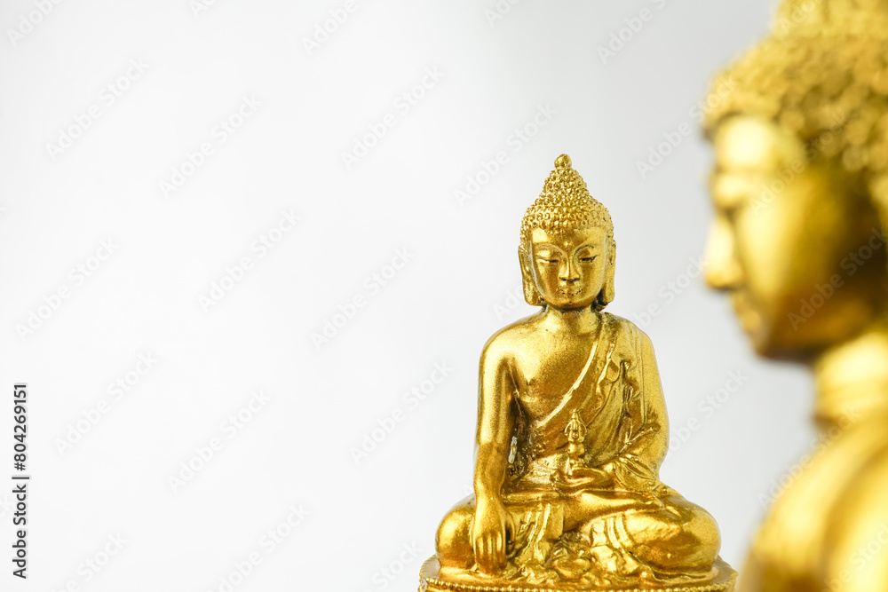 A golden statue of a Buddhist figure meditating facing the front isolated on white background. Bodhisattva Face. Concept for Vesak Day and Enlightenment Day