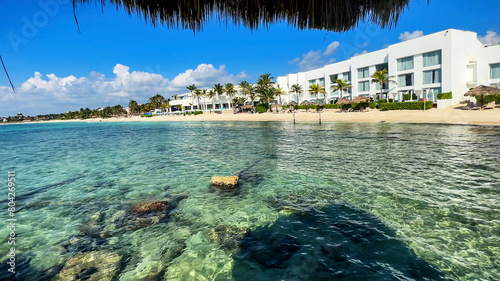 Great Resort on a paradisiacal beach in the Riviera Maya (Mexico). Vacation spot with white sand beaches, crystal clear turquoise water, blue sky and Caribbean sun ideal for relaxation.