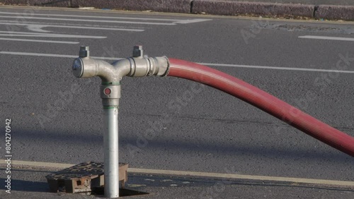 A well in a street has been opened and a fire hydrant connection point to supply water on road in england uk. photo