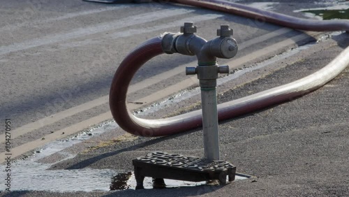 A well in a street has been opened and a fire hydrant connection point to supply water on road in england uk. photo