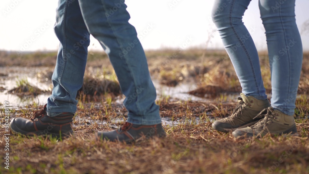 two tourists are traveling. active tourism and travel around the world concept. two tourists traveling together on foot close-up lifestyle walking through the Pine forest, legs