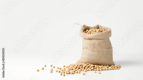 A burlap sack overflowing with soybeans on a clean white background, depicting a simple and natural look. photo