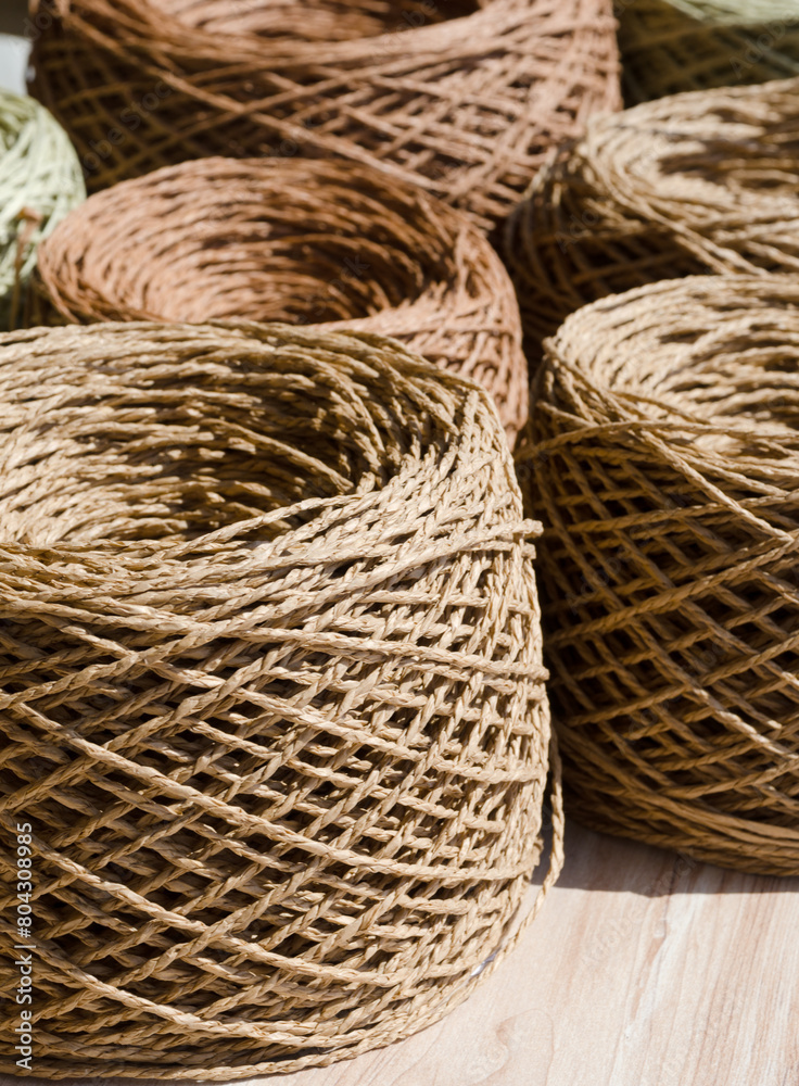 Raffia balls close-up on a burlap background.