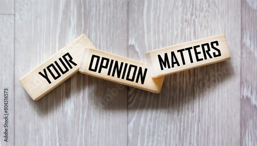 YOUR OPINION MATTERS is written on wooden blocks on a gray background. close-up