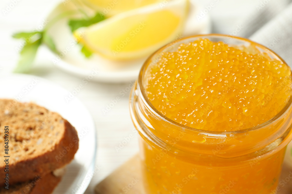 Fresh pike caviar in glass jar and bread on white wooden table, closeup Fresh pike caviar in glass jar and bread on white wooden table, closeup