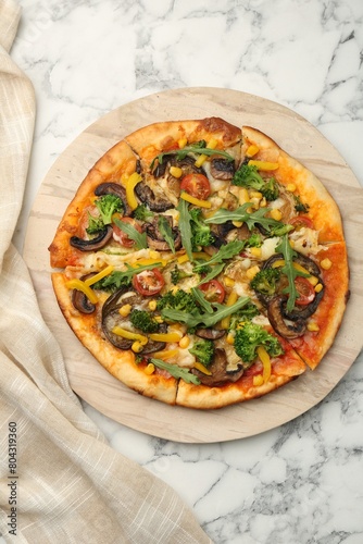 Delicious vegetarian pizza with mushrooms, vegetables and arugula on white marble table, top view