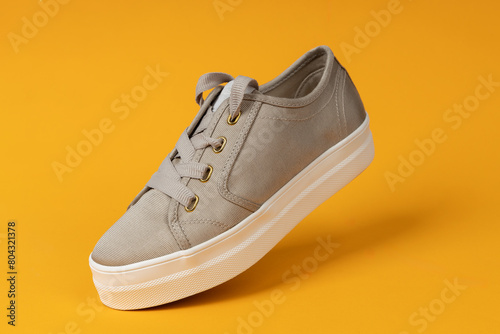 Female elegant, casual shoe. Yellow background. Fashion