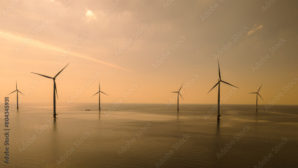A group of majestic wind turbines stand tall in the ocean off the coast of Flevoland, the Netherlands, harnessing the power of the wind to generate clean energy