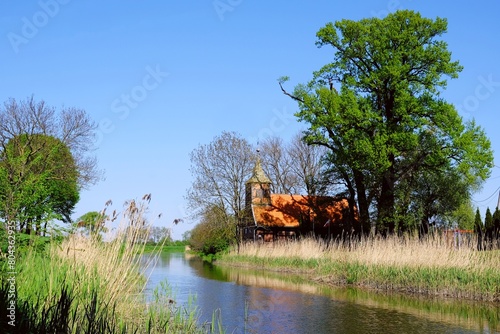 Historical half-timbered church by the river. Poland, Zulawy, Wroblewo photo