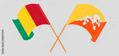 Crossed and waving flags of Guinea and Bhutan
