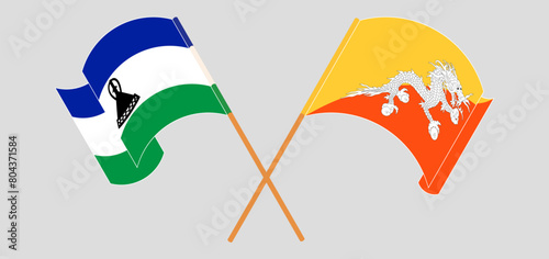Crossed and waving flags of Lesotho and Bhutan