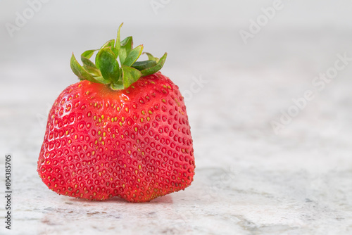 Closeup of a double strawberry on white granite counter