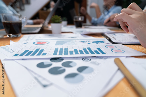 Focus financial data dashboard paperwork and blurred group of business people or analyst team analyzing business investment opportunity and perform research, data analysis and market trend. Habiliment