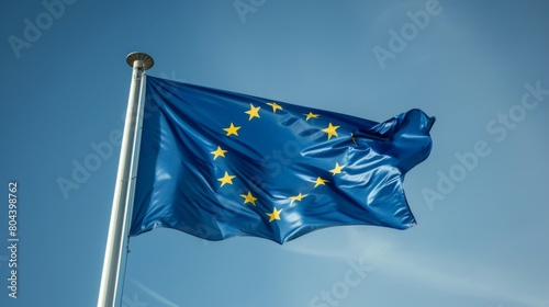 European Union flag fluttering proudly against a clear blue sky on a sunny day