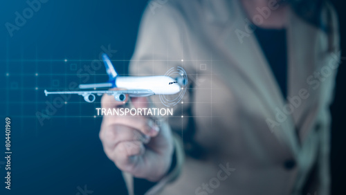 Businessman's hands holding airplane equipment, displaying a virtual screen of airplane transportation, ideal for aviation and travel concepts