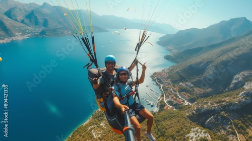 Two adventurers fly side by side on a paraglider on a sunny day