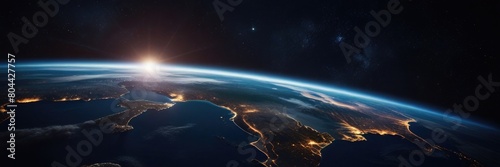 Planet Earth at night in outer space. Surface of the Earth. Sunrise view of the planet Earth from space with the sun setting over the horizon