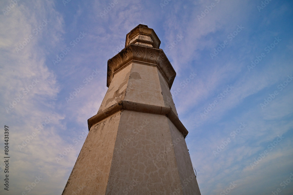 Ancient Minaret of Bibi-ka-Muqbara under blue skies and clouds, India.
