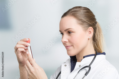 young female doctor with a blood probe in her hand