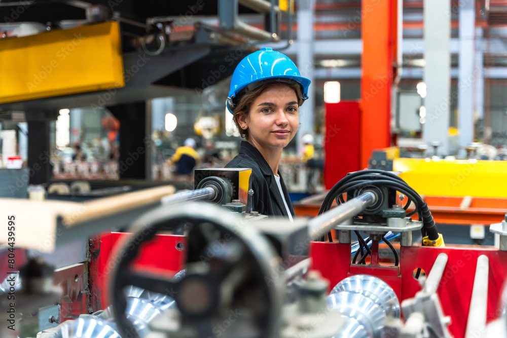 Young factory engineer woman working in metal sheet manufacturing industry Young factory engineer woman working in metal sheet manufacturing industry