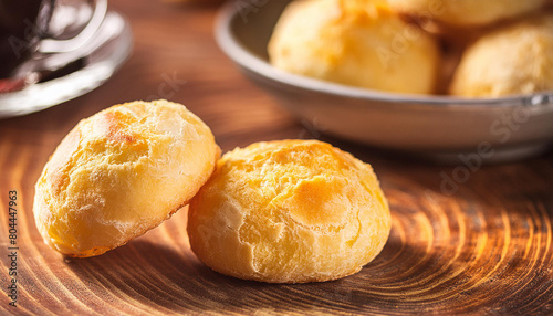 Close-up of Brazilian Pão de Queijo over wooden table. Cheese bread. Tasty meal. Delicious food